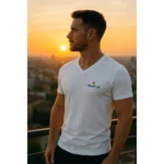 Bărbat purtând tricou alb cu anchior în V personalizat, apariție elegantă la apus în cadru urban