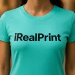 Detaliu personalizare logo iRealPrint aplicat prin transfer termic pe tricou damă verde smarald, imprimare clară pe material din bumbac