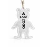 Prim-plan breloc reflectorizant personalizat alb tip animal, detaliu textură reflectorizantă și zonă de personalizare cu logo