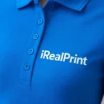 Detaliu logo aplicat prin transfer termic pe tricou polo damă personalizat albastru evidențiind claritatea printului și textura materialului premium
