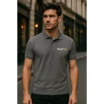 Bărbat purtând tricou polo gri metalic personalizat cu logo iRealPrint într-un cadru urban elegant, imagine profesională pentru branding de companie