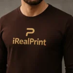 Detaliu bluză bărbați personalizată cafea cu logo iRealPrint auriu evidențiat pe fundal elegant pentru branding premium